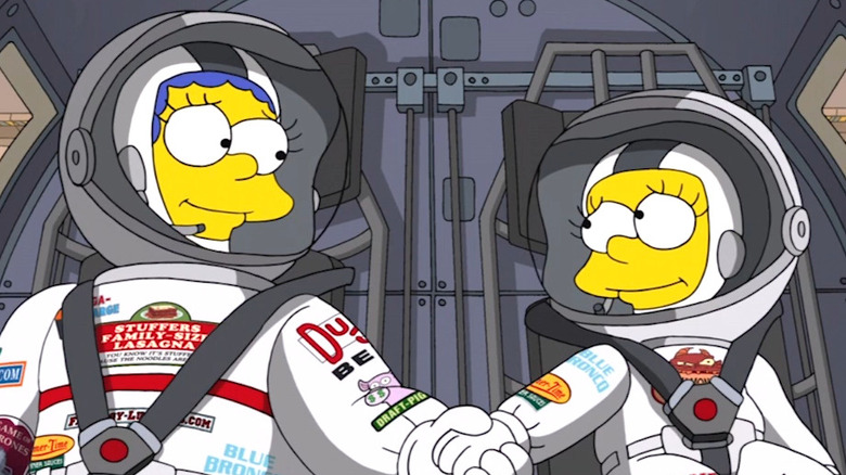 Marge and Lisa wearing spacesuits and holding hands in The Simpsons