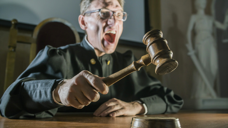 Angry judge banging gavel