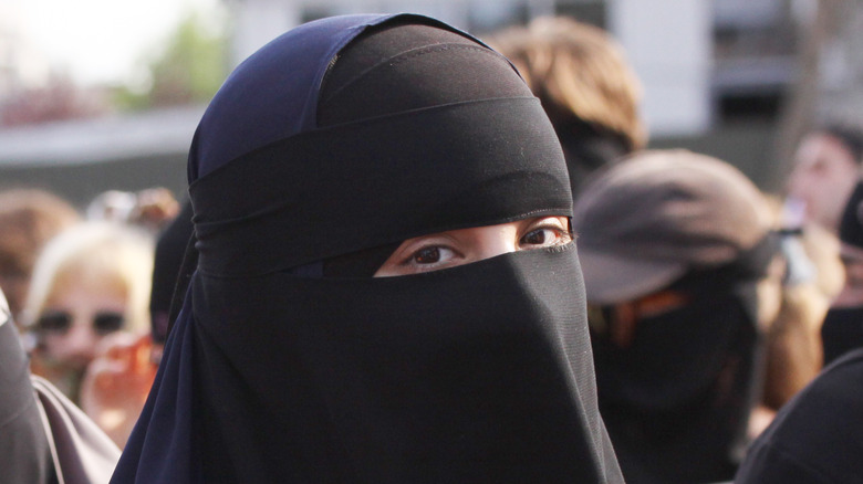 A woman talks while in a chador