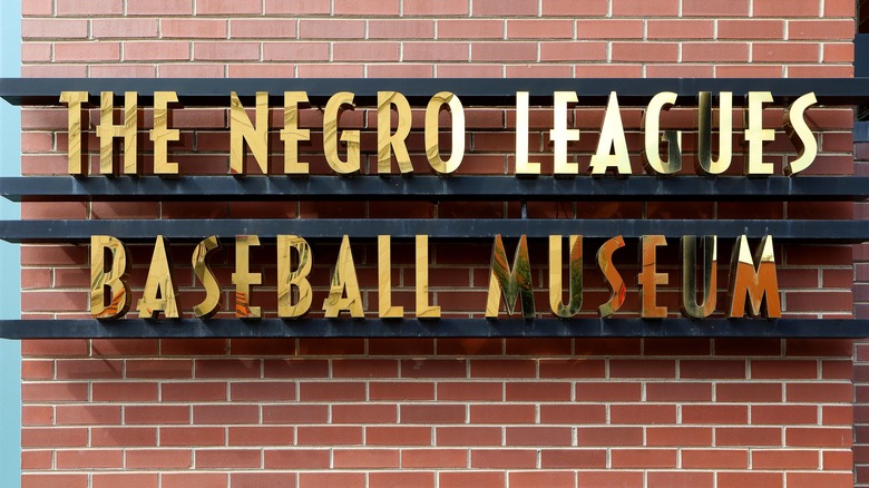 The Negro Leagues Baseball Museum gold sign on brick wall