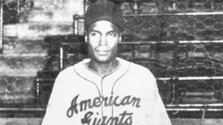 Baseball player in uniform looking forward in stand