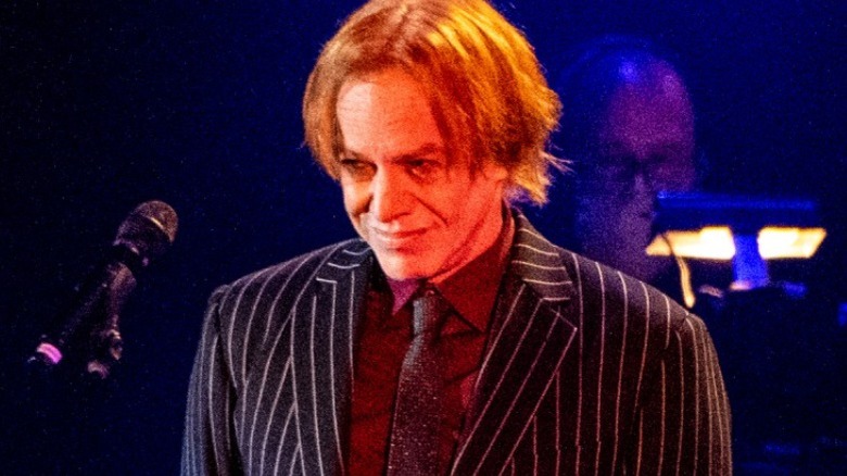 Elfman smiling on stage in 2021