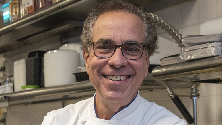 michael lomonaco smiling in kitchen