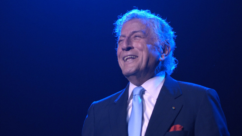 Tony Bennett on stage in blue suit and tie