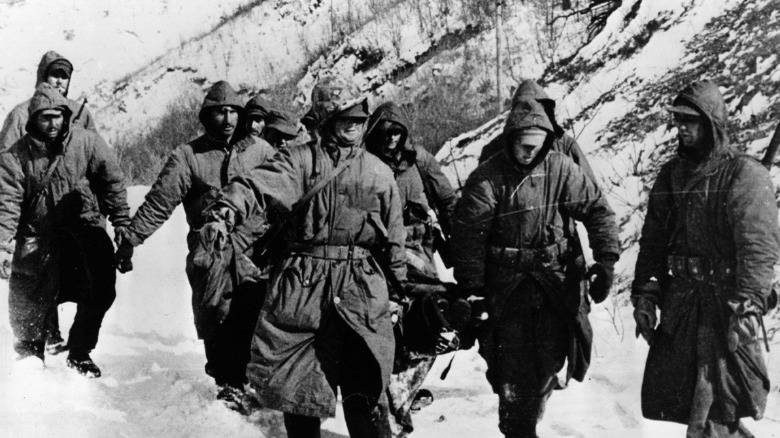 Marines carrying wounded comrade