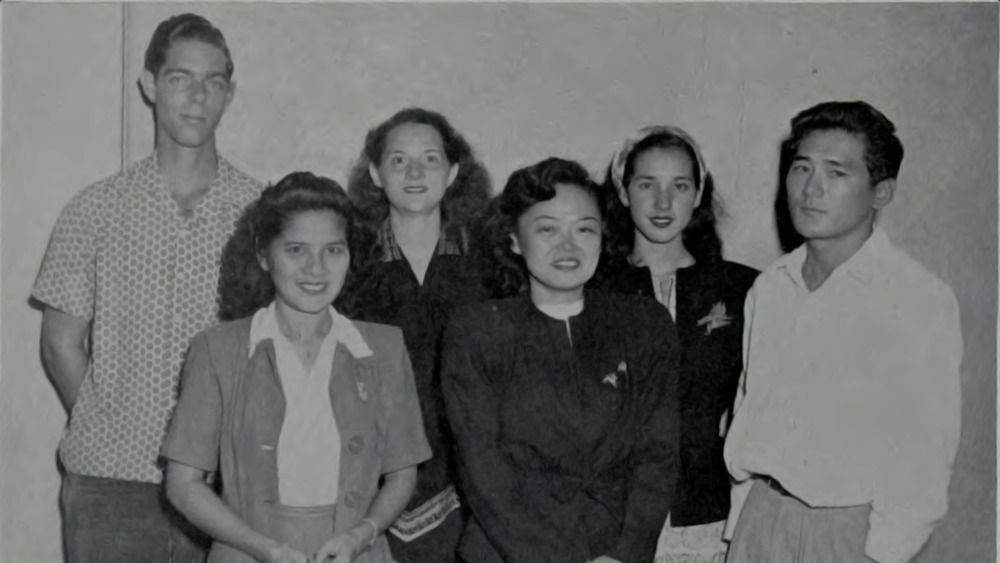 Patsy Takemoto Mink poses for a photo with a group of five 