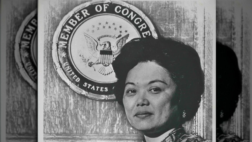 Patsy Mink in front of congressional seal 