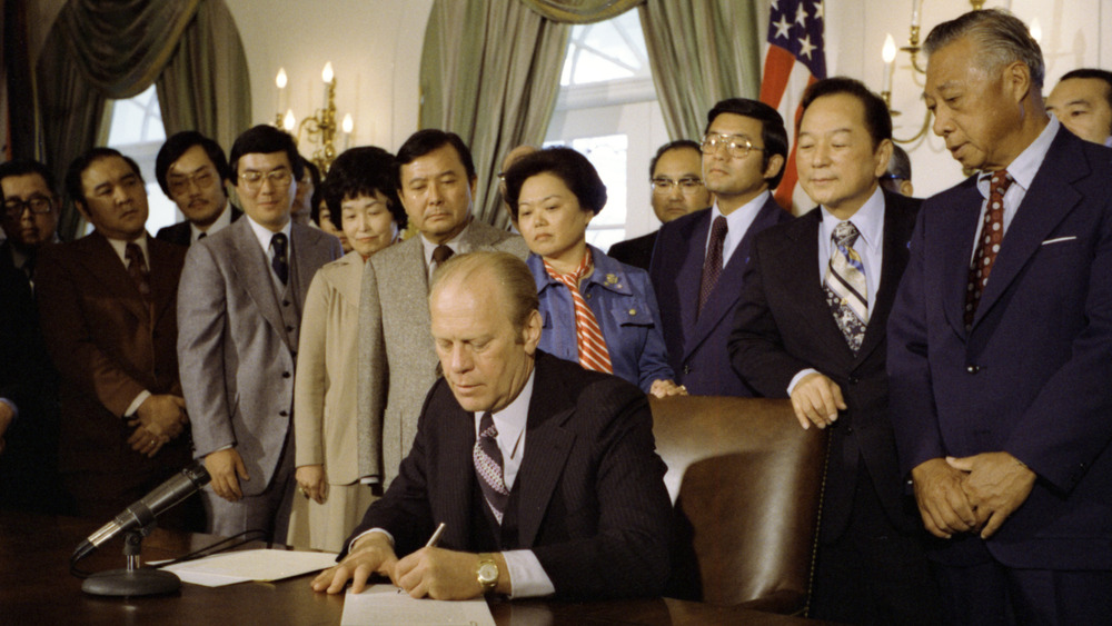 Congresswoman Patsy T. Mink watches with others 