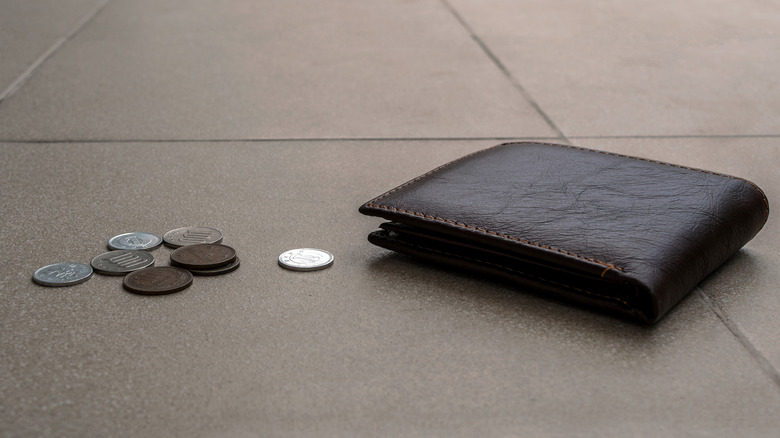 Wallet and coins on ground