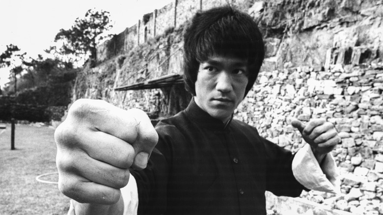 Bruce Lee black outfit fists raised