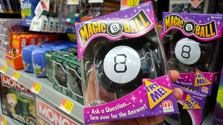 Magic 8 Ball on a game shelf