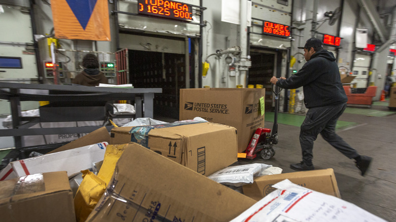 Man walking in U.S.P.S warehouse