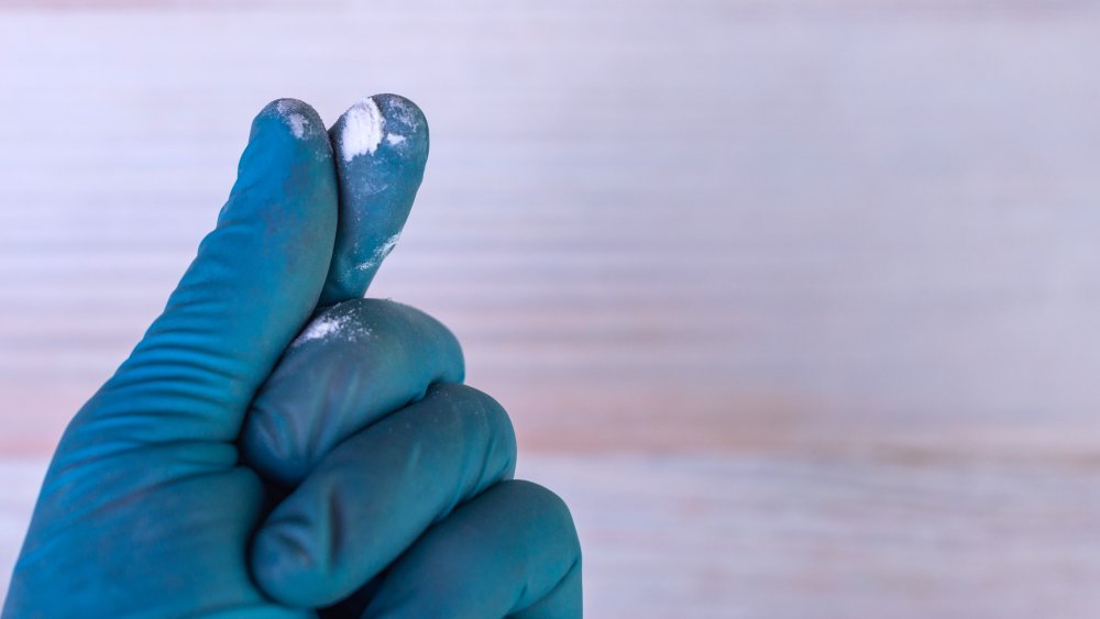 A medical expert holds up a heroin sample