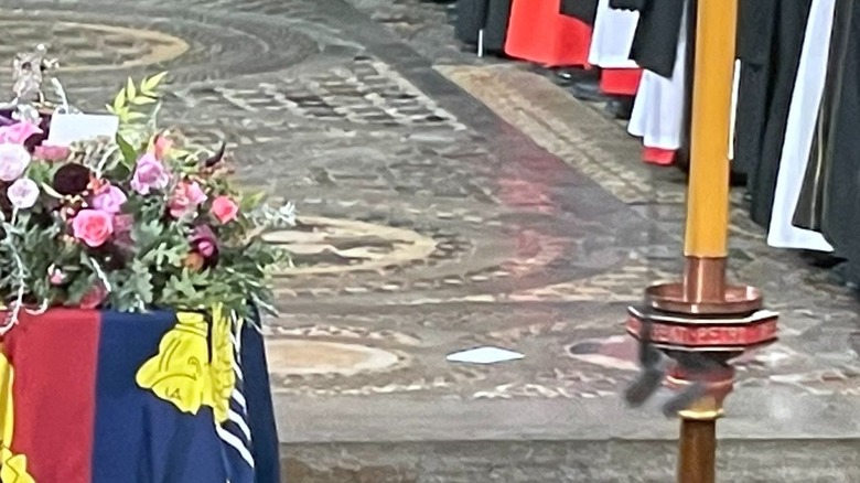 Paper lying on floor at queen's funeral