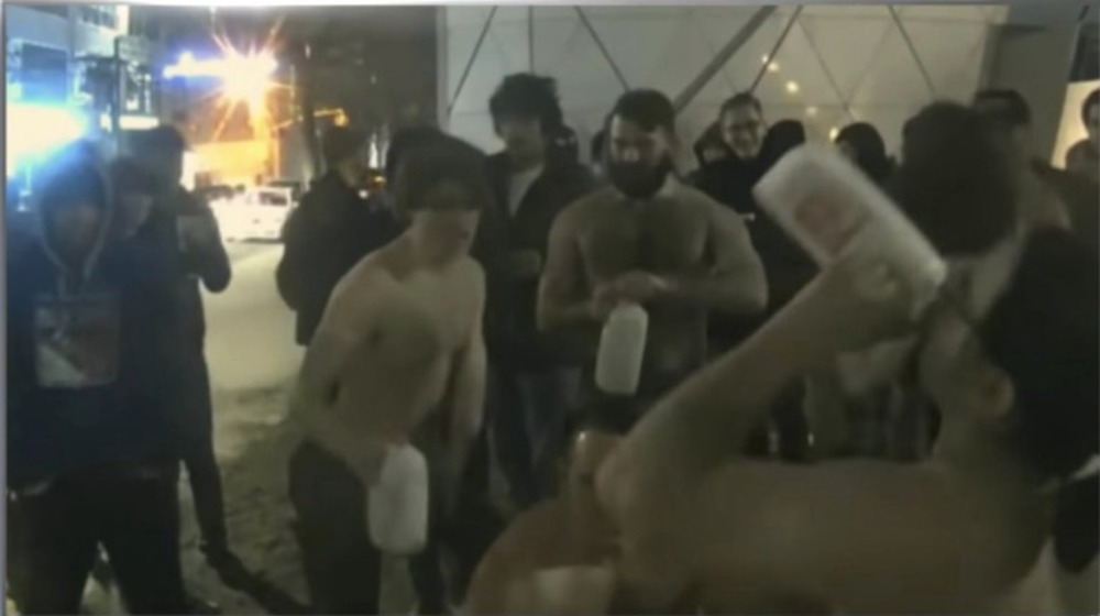 shirtless men chugging milk