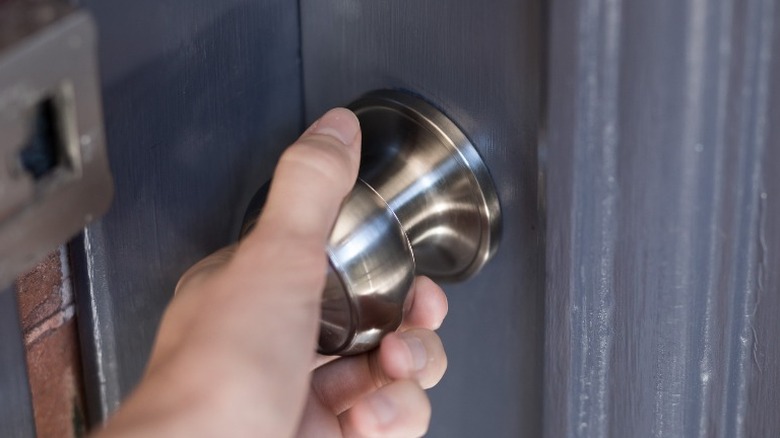 Man Reaching Toward Door