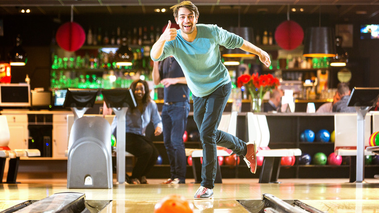 man thumbs up bowling smiling