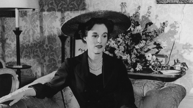 Babe Paley hat dark suit lounging