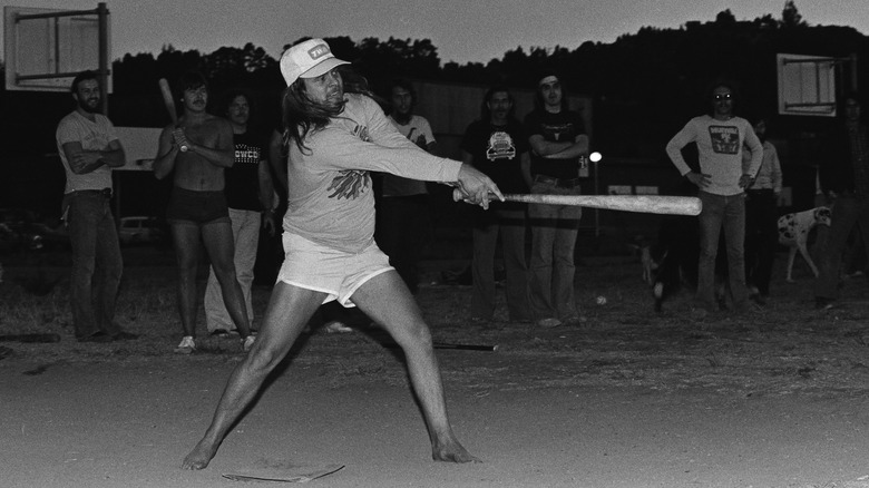 Ronnie Van Zant swings a bat