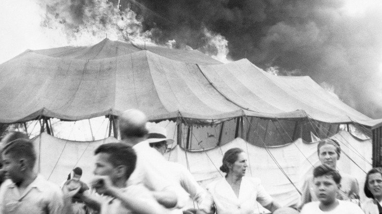 The big top burning while people flee