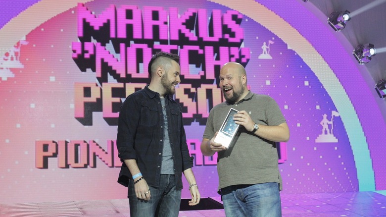 Markus Persson smiling with award