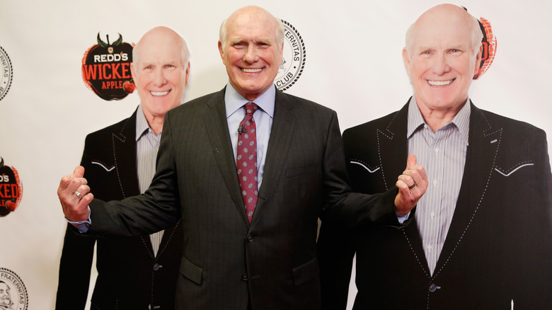 Terry Bradshaw with cardboard cutouts of himself