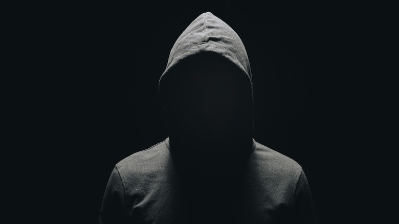 faceless man in hoodie