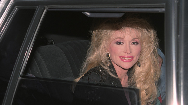 Dolly Parton smiling through car window