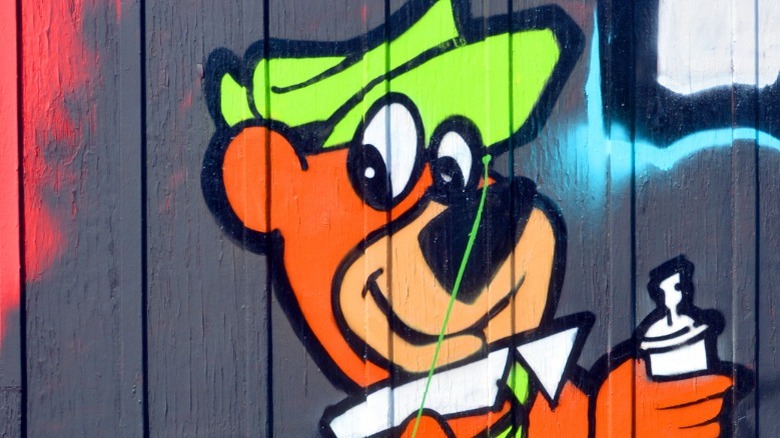 Yogi Bear cartoon painted on fence