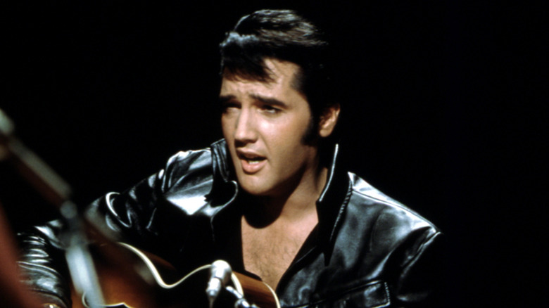 Elvis Presley holding guitar