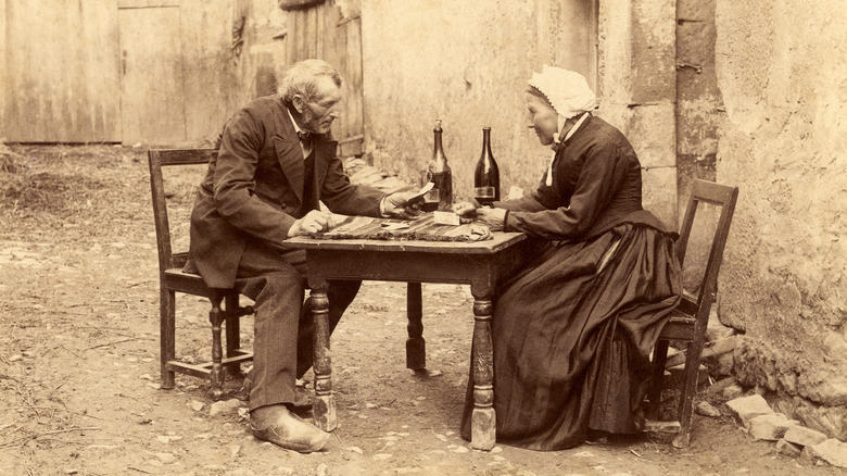 French peasants playing cards sepia photograph
