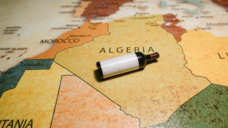 bottle of red wine on map of Algeria