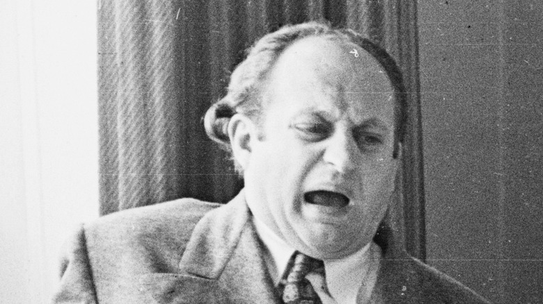 Larry Fine pulls a face