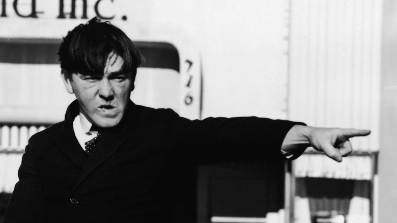 Moe Howard pointing a finger