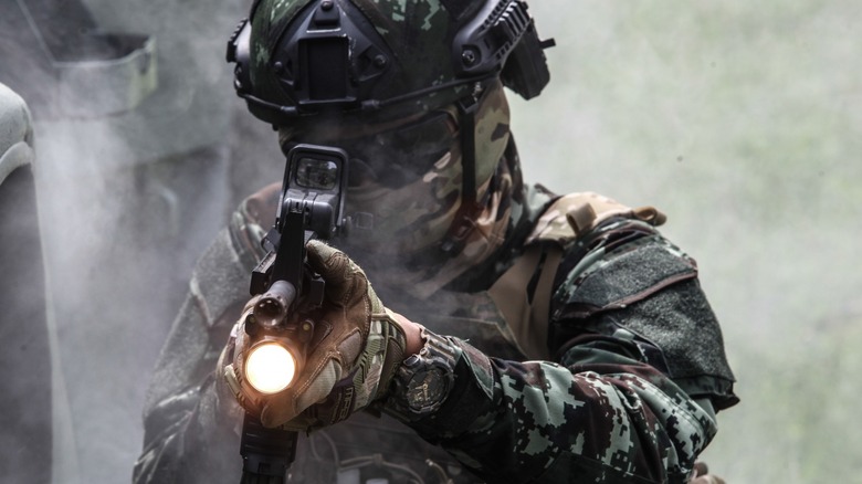 US soldier aiming rifle