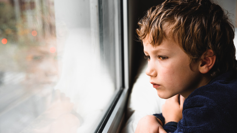 Boy looking out of window