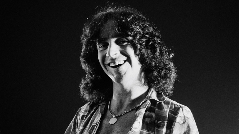 bon scott smiling necklace long hair black and white photo