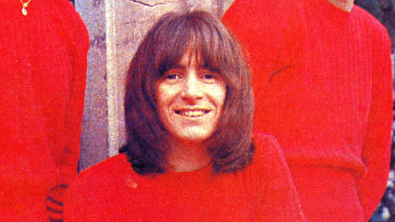 bon scott smiling in red shirt in publicity photo with the valentines