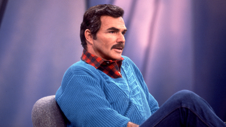 Burt Reynolds sitting on a couch