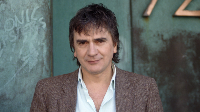 Dudley Moore grey suit smiling green door