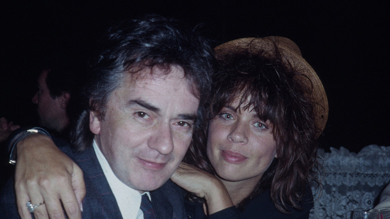 Nicole Rothschild arms around Dudley Moore smiling at event