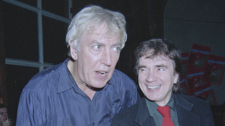 Peter Cook with Dudley Moore smiling at event