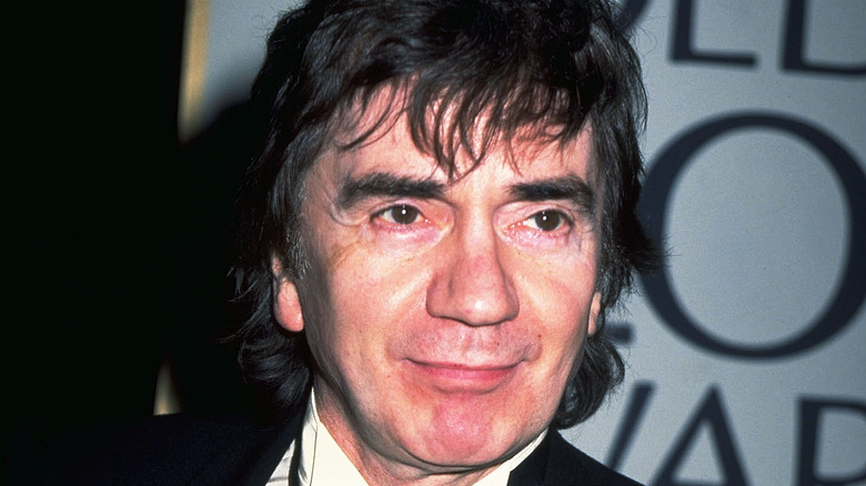 Dudley Moore suit smiling at event