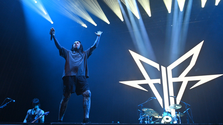 Falling in Reverse performing illuminated band logo