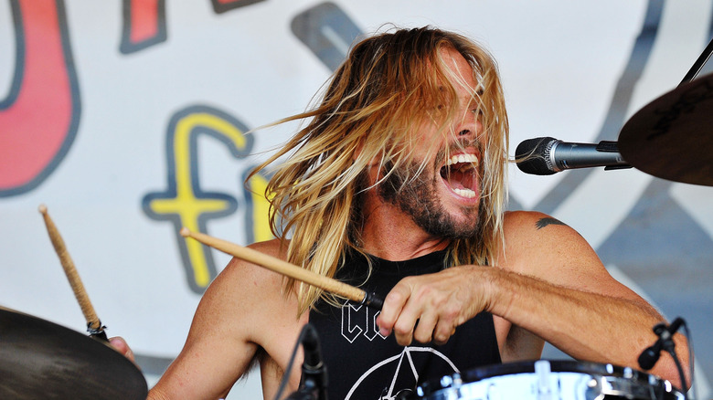 Taylor Hawkins drums onstage performing