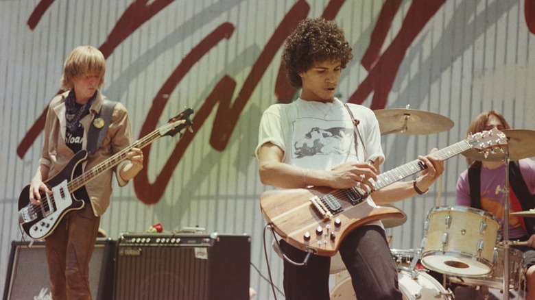 Slash on stage performing in school