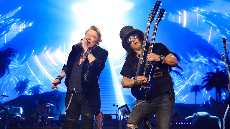 Slash and Axl Rose performing on stage