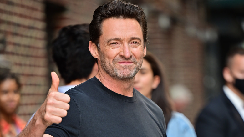 Hugh Jackman black shirt smiling thumbs-up