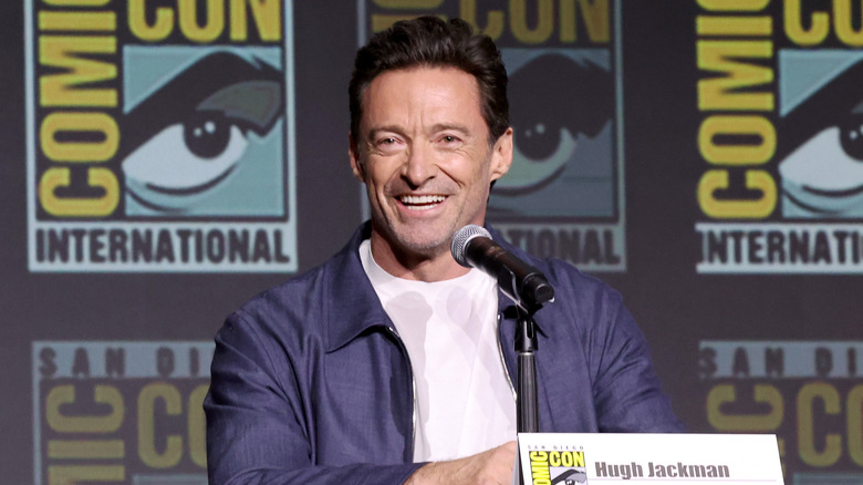 Hugh Jackman white shirt blue jacket smiling talking at event