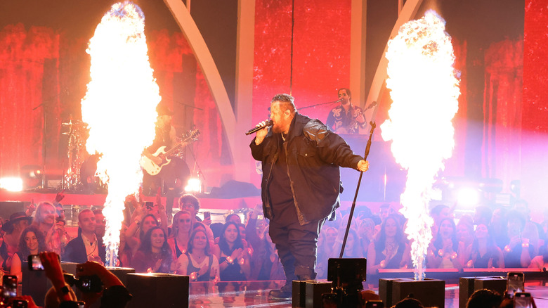 Jelly Roll performing on stage with pyrotechnics